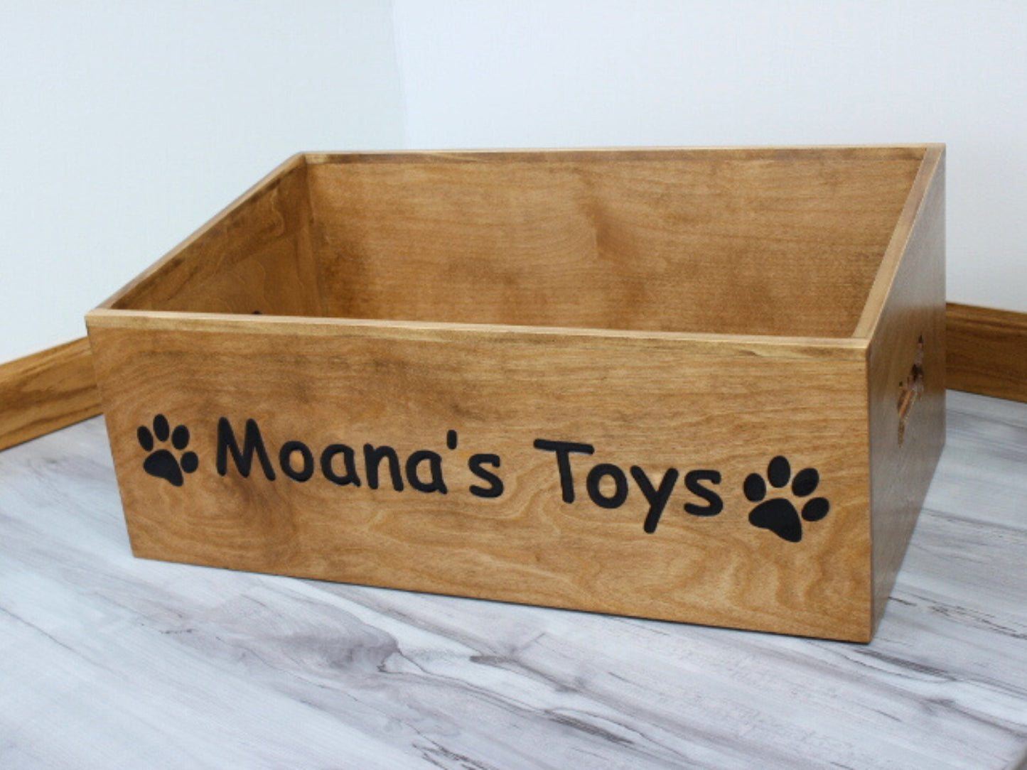 Custom Wooden Dog Box Stained pecan with black epoxy that reads Moana's Toys