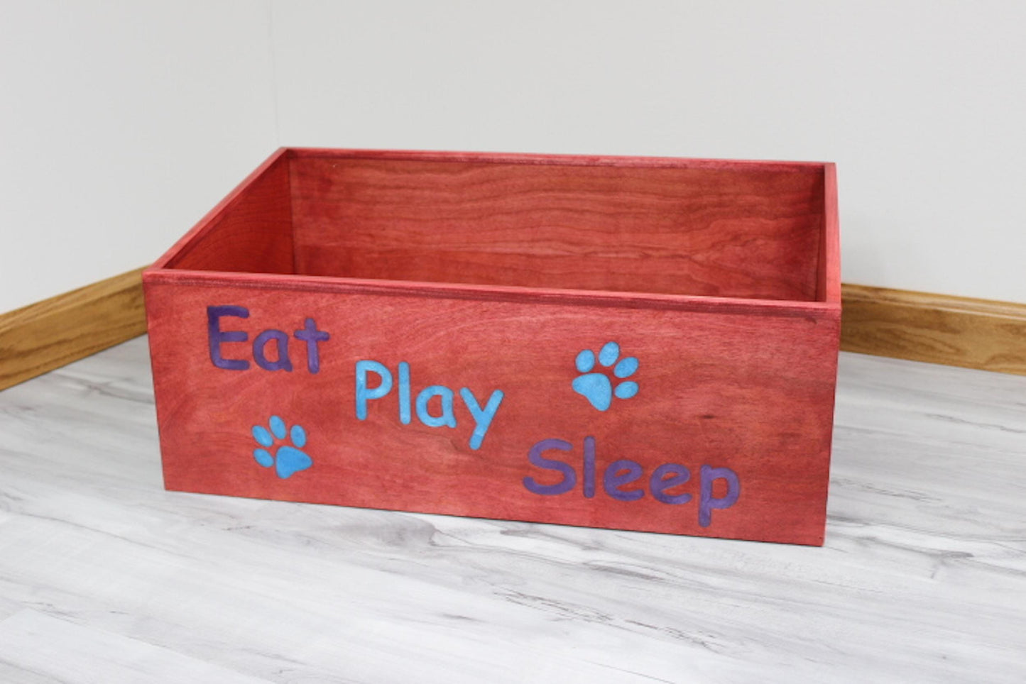 Custom wooden dog box that is stained Barn red with Eat Play Sleep with Purple and Blue Epoxy